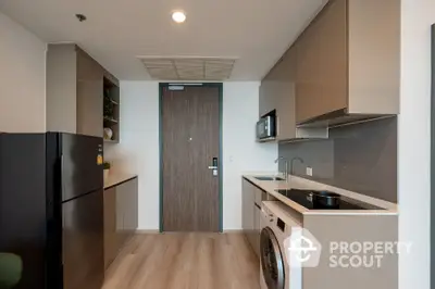 Modern kitchen with sleek cabinetry and integrated appliances in a stylish apartment.