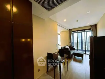 Modern living room with city view and balcony access in a stylish apartment.