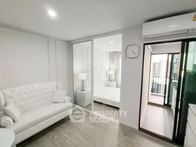 Modern apartment interior with elegant white furniture and balcony view