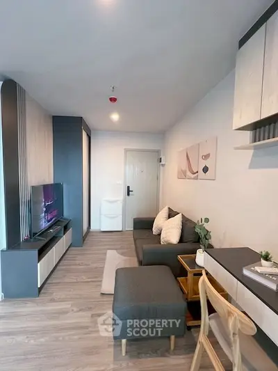 Modern living room with stylish decor, cozy seating, and sleek entertainment center in a contemporary apartment.