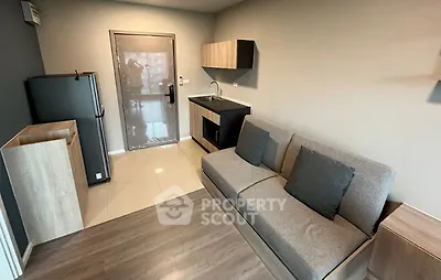 Modern compact living room with kitchenette and sleek design