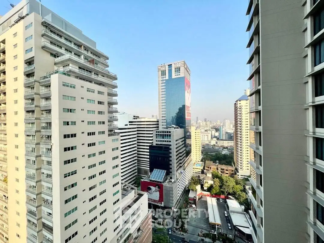 Stunning cityscape view from high-rise building balcony in urban setting.
