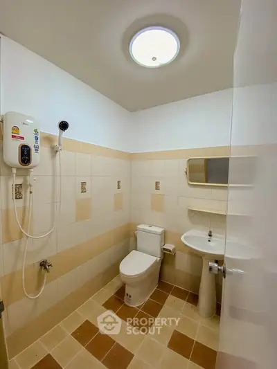 Modern bathroom with tiled walls, shower, and sleek fixtures in a contemporary home.