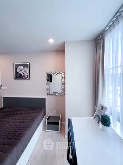Modern bedroom with stylish decor and natural light, featuring a cozy bed and functional workspace.