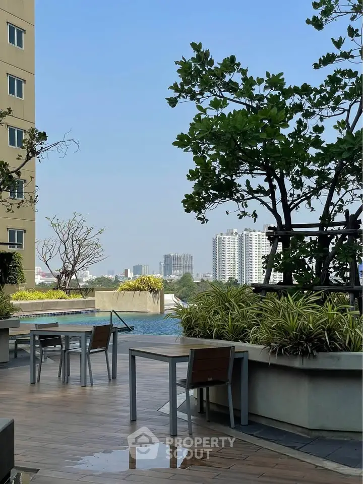 Luxurious high-rise pool area with city views and modern outdoor seating.