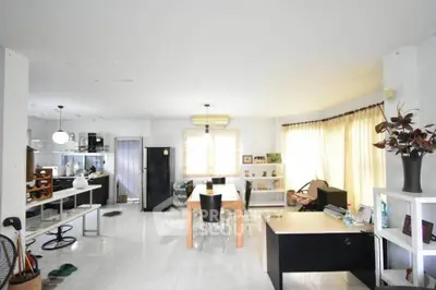 Spacious open-plan living and dining area with modern decor and natural light.