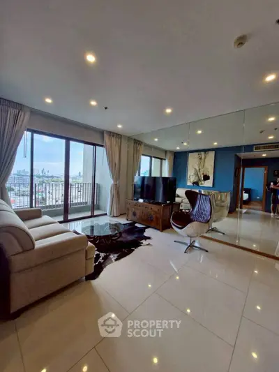 Spacious living room with city view, modern furniture, and large windows in a high-rise apartment.