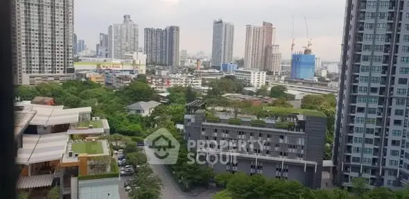 Stunning cityscape view with modern high-rise buildings and lush greenery.