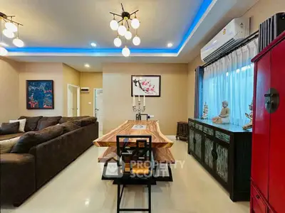 Stylish living room with modern lighting, cozy sofa, and elegant dining area in a contemporary home.