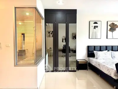 Modern bedroom with stylish decor and glass partitioned study area