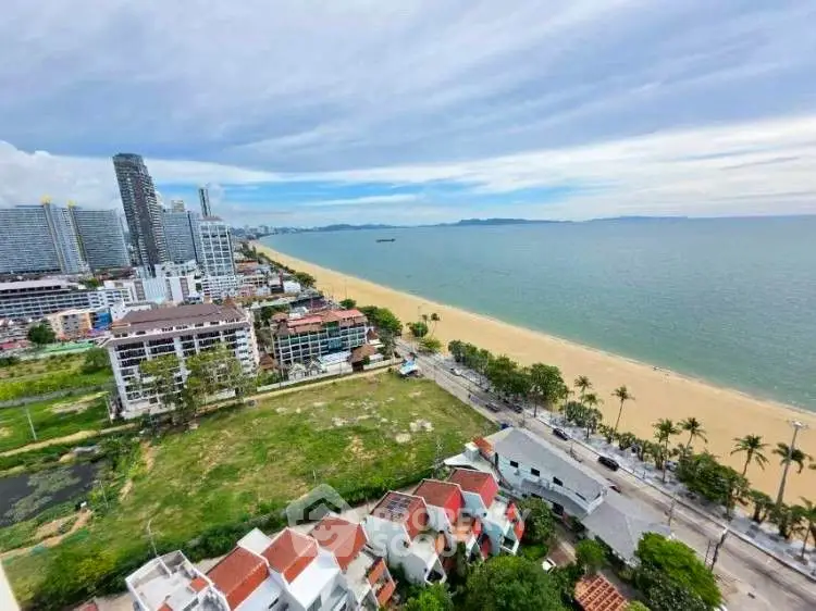 Stunning beachfront view from high-rise apartment overlooking ocean and cityscape.