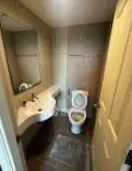 Compact bathroom with modern fixtures and neutral tiles