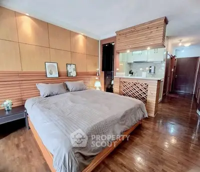 Spacious bedroom with modern decor and open kitchen layout