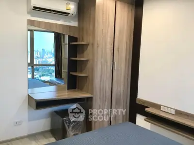 Modern bedroom with city view, featuring stylish wooden furniture and air conditioning.