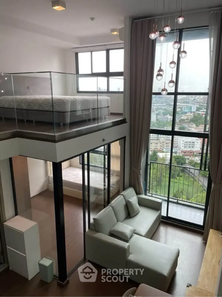 Modern loft apartment with high ceilings and stunning city view from large windows.