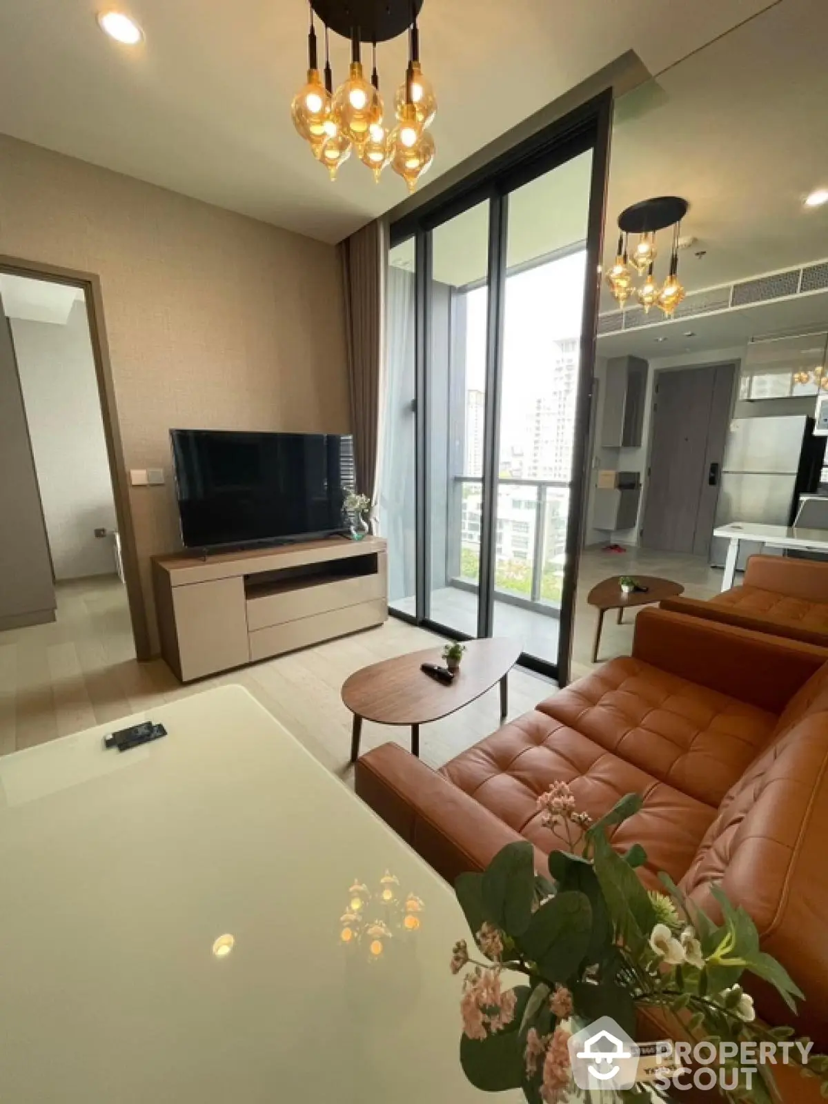 Modern living room with leather sofa and balcony view in luxury apartment