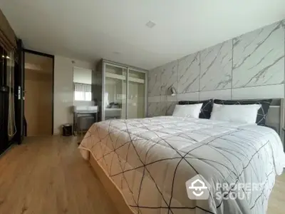 Modern bedroom with stylish decor and spacious layout in a luxury apartment.