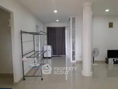 Spacious modern living area with sleek flooring and minimalist decor.