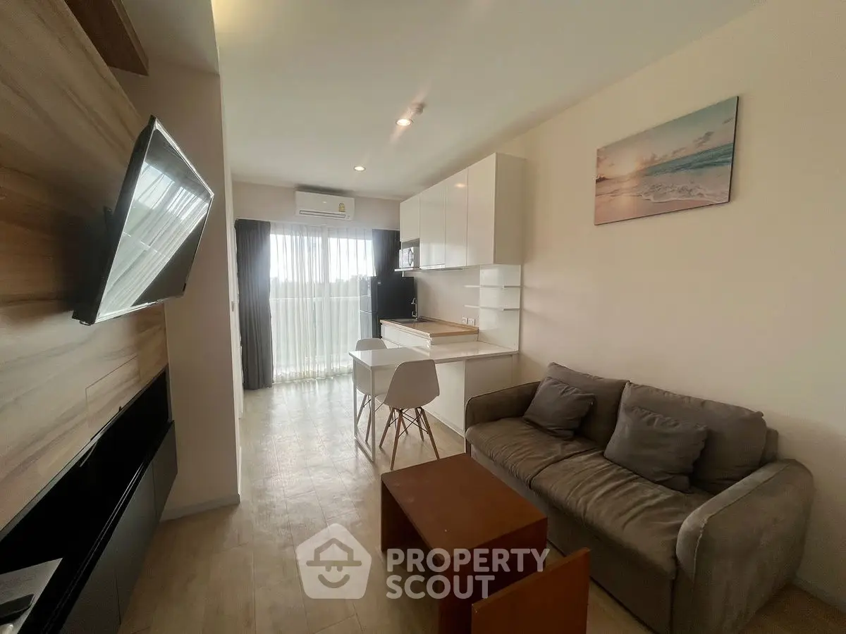 Modern living room with open kitchen and cozy seating area
