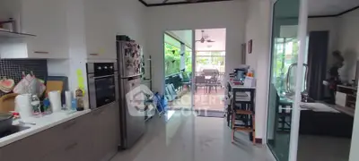 Spacious kitchen with modern appliances and open layout leading to a bright dining area.