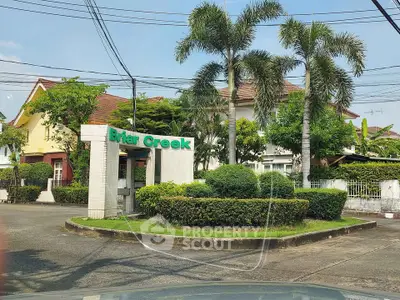 Charming residential entrance with lush greenery and palm trees at Briar Creek.