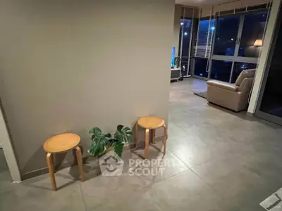 Modern living room with stylish decor and large windows for natural light.