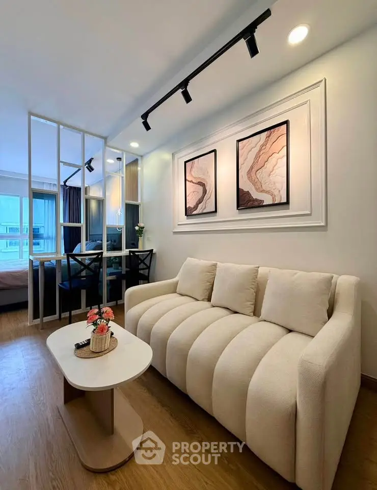 Modern living room with elegant decor and cozy seating in a stylish apartment.
