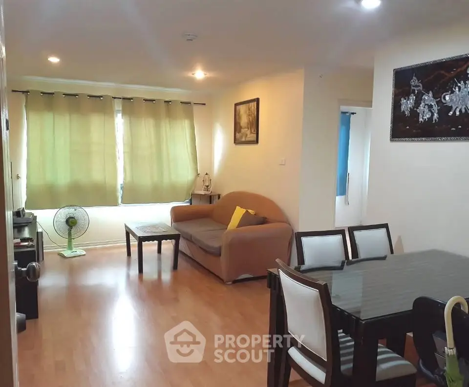 Spacious living room with dining area and cozy seating in modern apartment.