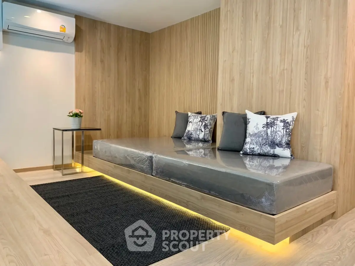 Modern living room with stylish wooden paneling and sleek floating sofa