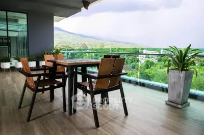 Spacious balcony with modern furniture and stunning mountain view