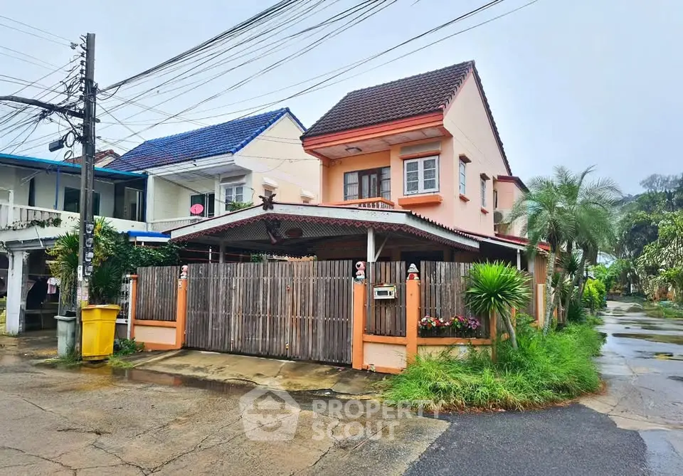 Charming suburban house with gated entrance and lush greenery