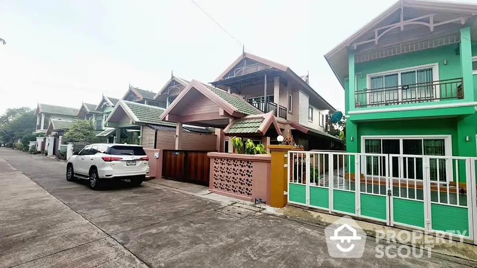 Charming suburban street with colorful houses and parked car, ideal for family living.