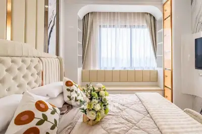 Luxurious bedroom with elegant decor and large window seating area