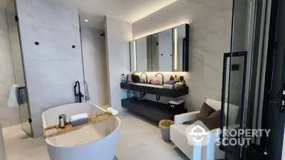 Luxurious modern bathroom with freestanding bathtub and elegant vanity area.