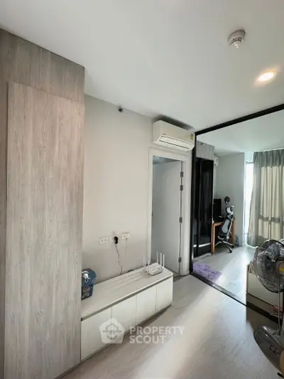 Modern bedroom with mirrored closet and sleek air conditioning unit