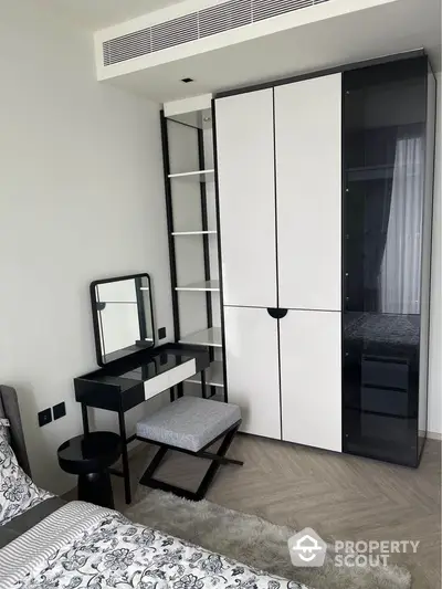 Modern bedroom with sleek wardrobe and stylish vanity in contemporary apartment