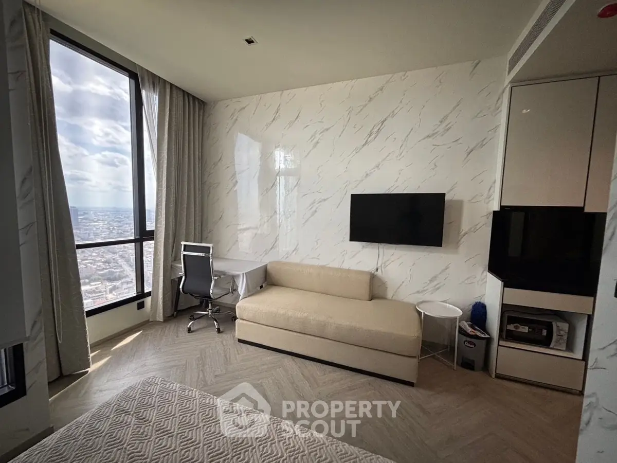 Modern living room with city view, sleek furniture, and elegant decor