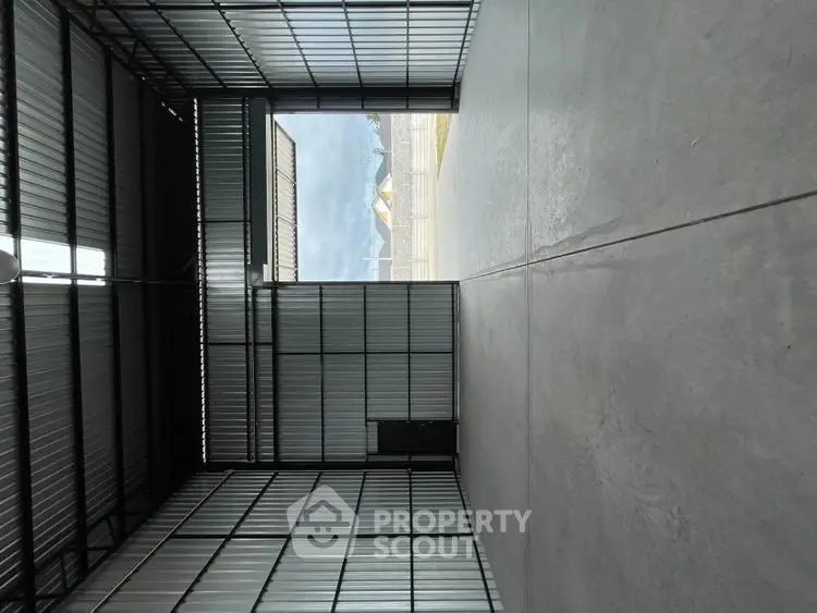 Spacious industrial warehouse with high ceilings and large entryway.