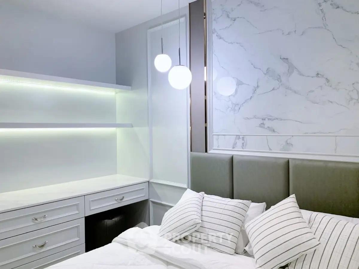 Modern bedroom with elegant marble accent wall and stylish lighting