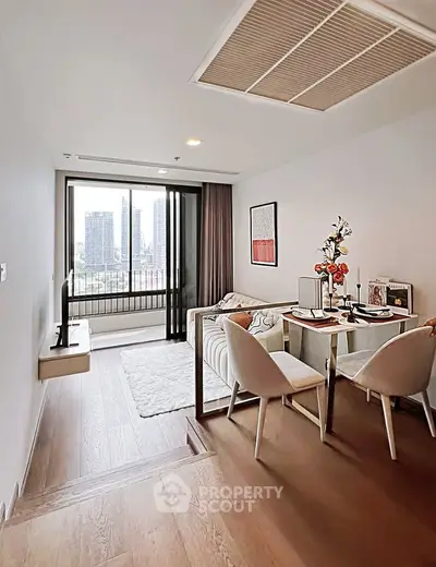 Modern living room with city view, featuring stylish dining area and cozy seating, perfect for urban living.