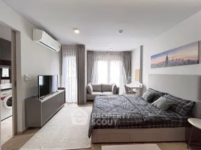 Modern bedroom with stylish decor and natural light, featuring a cozy bed and sleek furniture.