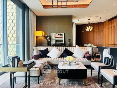 Luxurious modern living room with elegant decor and large windows offering natural light.