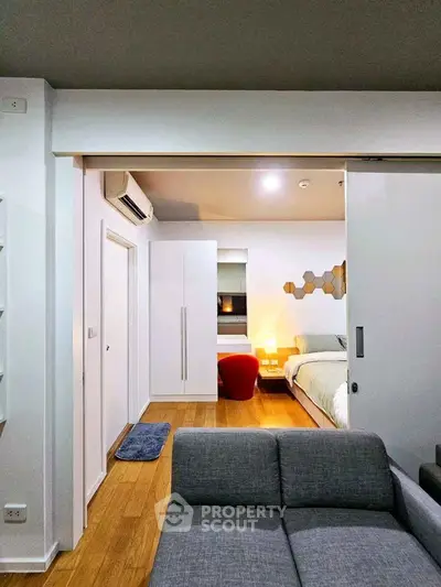 Modern bedroom with stylish decor and cozy ambiance, featuring a comfortable bed and sleek furniture.
