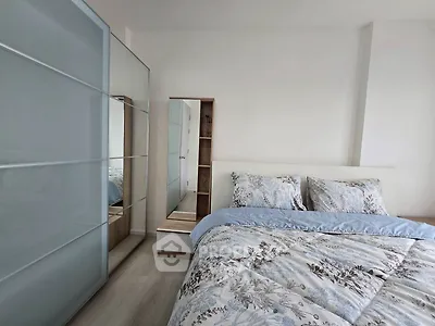 Modern bedroom with stylish bedding and sleek wardrobe design
