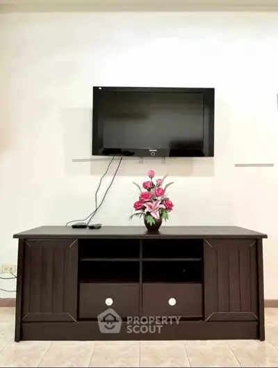 Modern living room with wall-mounted TV and elegant console table.