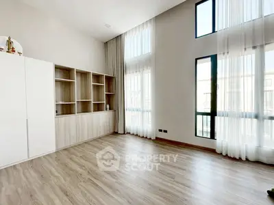 Spacious modern living room with high ceilings and large windows