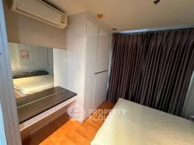 Cozy bedroom with modern decor, featuring a large wardrobe and elegant curtains.