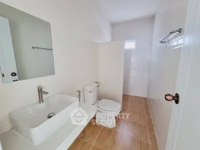Modern minimalist bathroom with white tiles and wooden floor