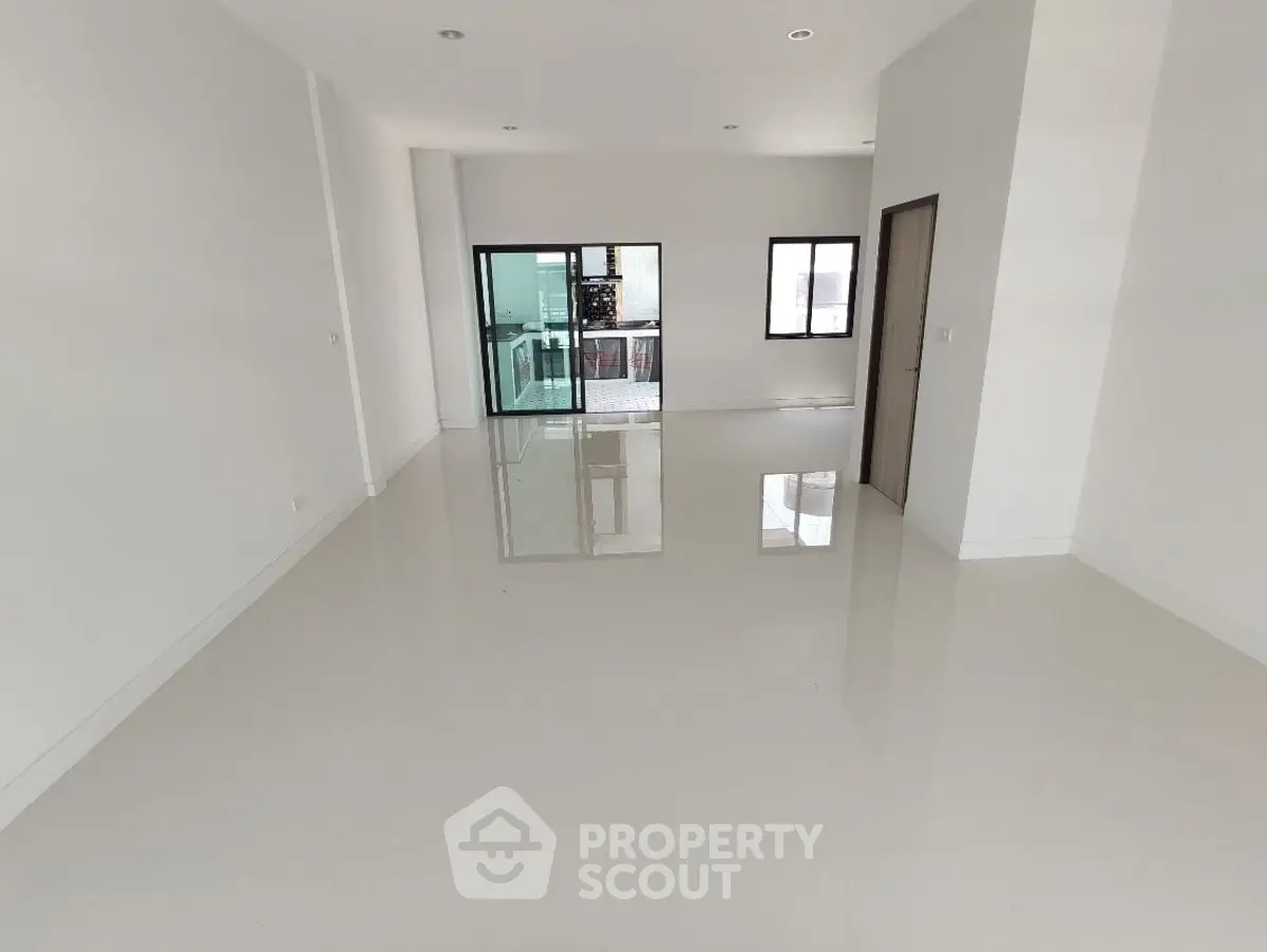 Spacious modern living room with glossy floors and large windows