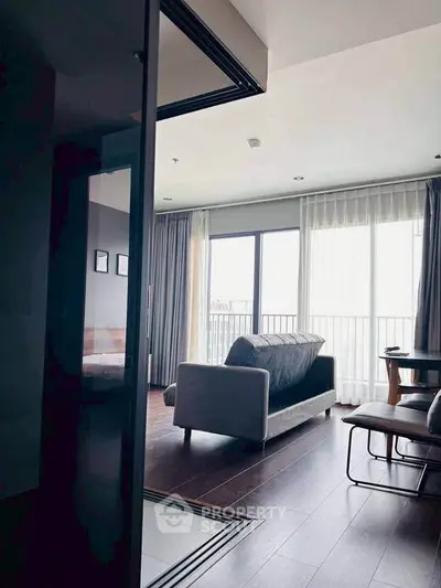 Modern living room with large windows and stylish furniture in a contemporary apartment.